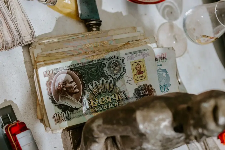 Close-up of vintage Soviet 1000 ruble notes on a tabletop with various objects.