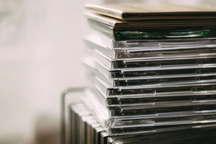 A stack of transparent CD cases neatly aligned, creating a still life composition.