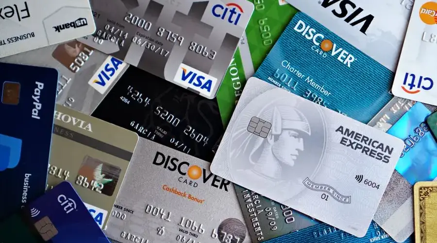 A flat lay of assorted credit and debit cards from various banks. Ideal for finance and banking concepts.