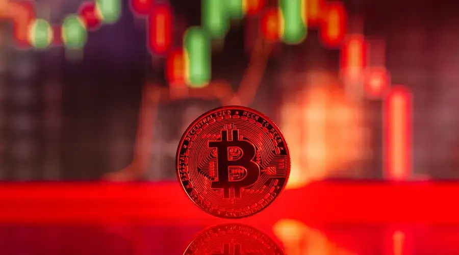 Close-up image of a Bitcoin coin with trading graph reflection, symbolizing cryptocurrency market dynamics.