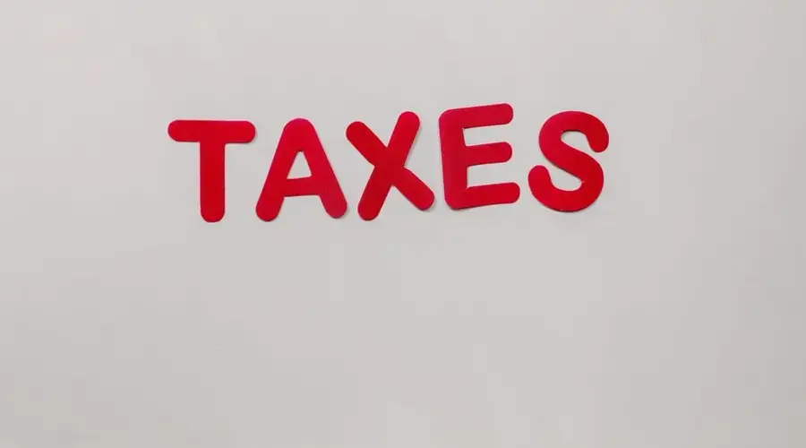 Simple and bold image of the word taxes in red letters on a white background.