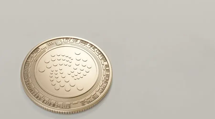 High-quality image of a gold IOTA cryptocurrency coin on a plain background, ideal for finance concepts.