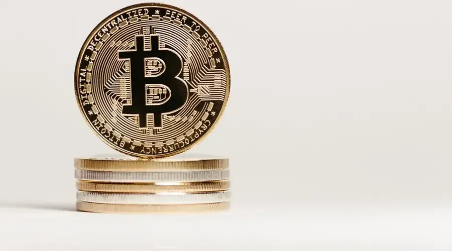 Golden Bitcoin displayed prominently on a white background showcasing cryptocurrency value.