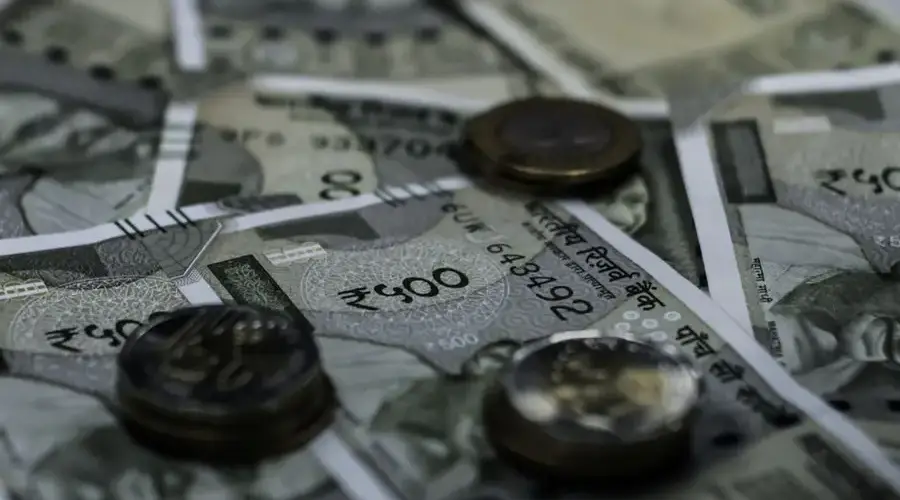 Detailed view of Indian currency notes and coins representing wealth and finance.