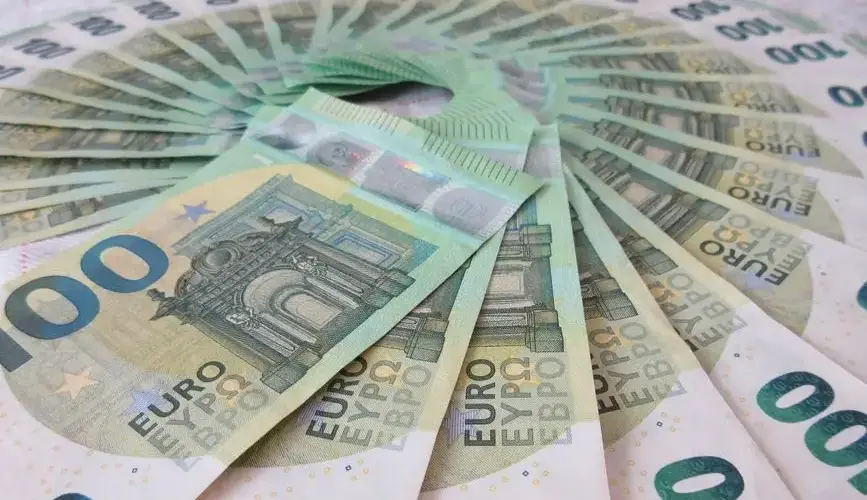 Close-up of fan spread 100 Euro banknotes, showcasing wealth and finance theme.