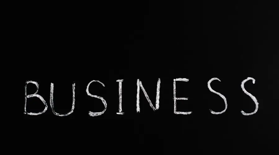 White chalk letters spelling 'BUSINESS' on a blackboard. Simple yet powerful conceptual design.