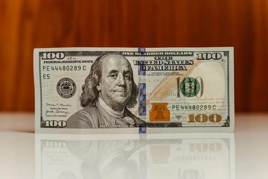 High-resolution image of a one hundred dollar bill with Benjamin Franklin, featuring clear details and reflective surface.