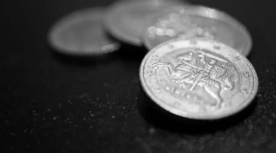 Macro photograph of stacked coins in black and white, highlighting finance and wealth.