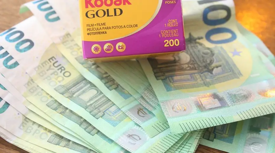 Close-up of Kodak Gold film box placed on 100 euro banknotes.