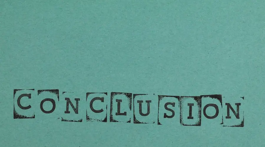 Conclusion word stamped on textured blue paper with block letters, conveying finality.