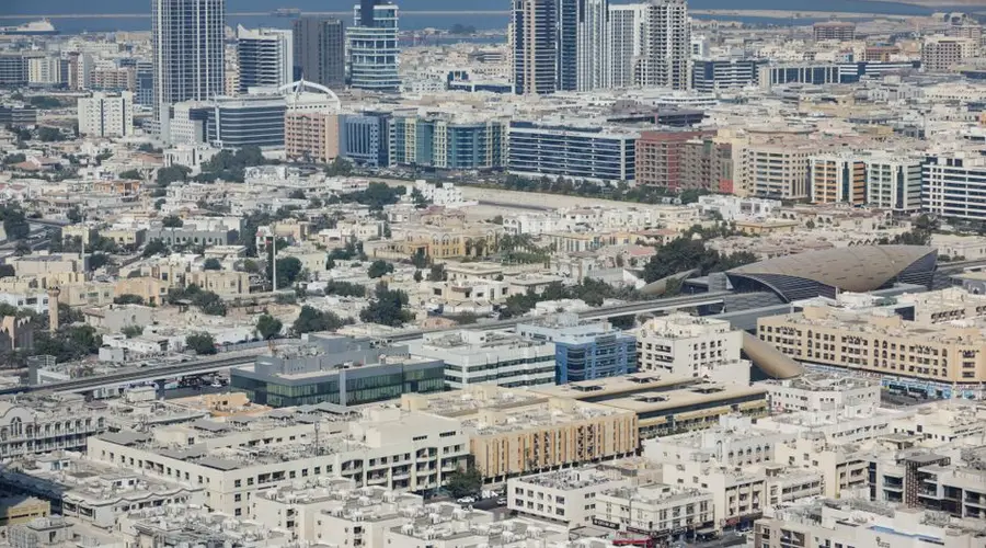 Expansive aerial shot capturing Dubai's modern cityscape with diverse architecture and bustling urban life.