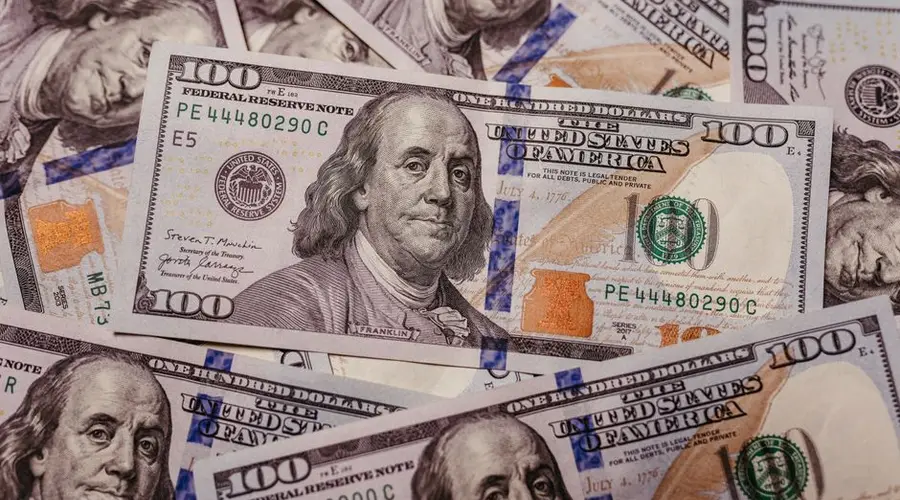 Stack of 100 dollar US banknotes with Benjamin Franklin portrait.