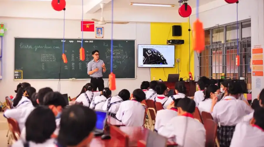 Teacher conducts an interactive lesson in a vibrant classroom setting with attentive students.