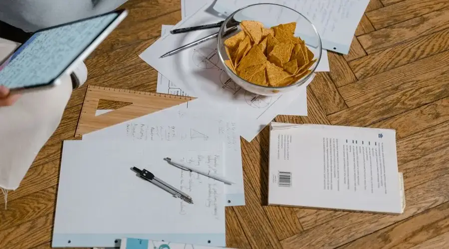 A cozy study session with notes, snacks, and digital devices, perfect for elearning.