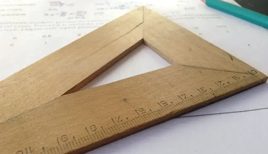 Close-up of a wooden ruler on paper, ideal for educational themes and measuring concepts.