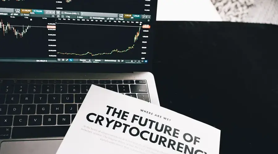 A detailed look at cryptocurrency market trends using a laptop and analytical document.