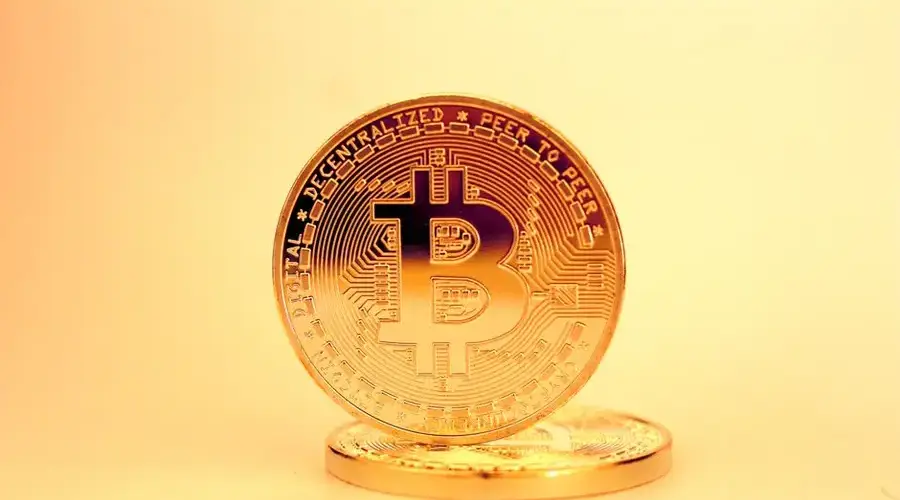 A close-up of a golden Bitcoin highlighting its digital currency design.