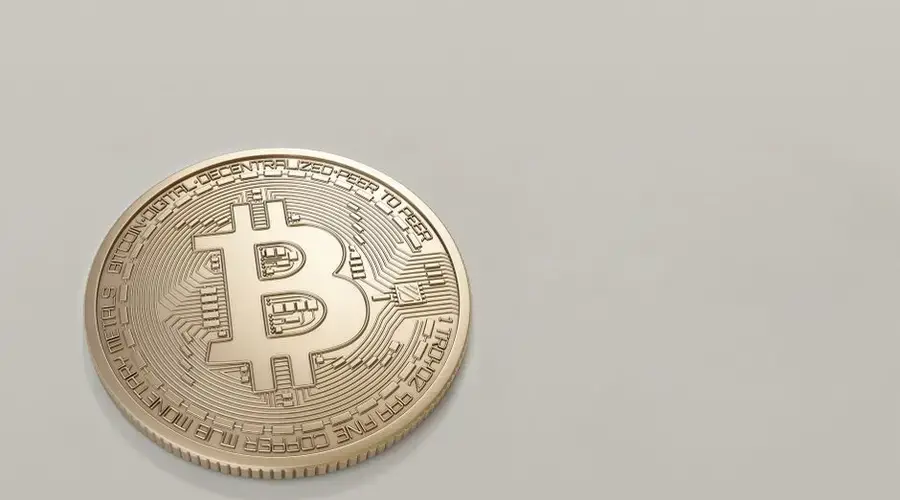 A detailed image of a Bitcoin cryptocurrency coin with a neutral background, symbolizing digital finance and currency.