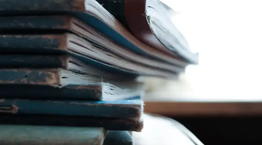 Artistic close-up of a stack of worn out notebooks with a vintage feel.