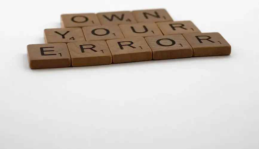 A motivational phrase assembled with Scrabble tiles on a white background.