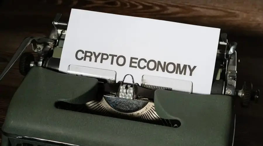 Close-up of a vintage typewriter with paper reading 'Crypto Economy', symbolizing modern concepts with retro technology.
