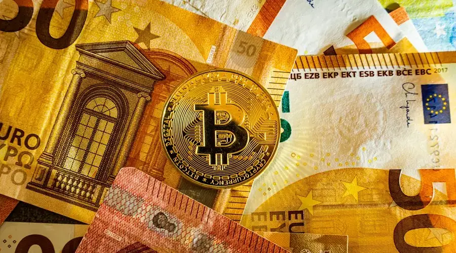 Golden Bitcoin coin placed on euro banknotes symbolizing digital currency and modern finance.