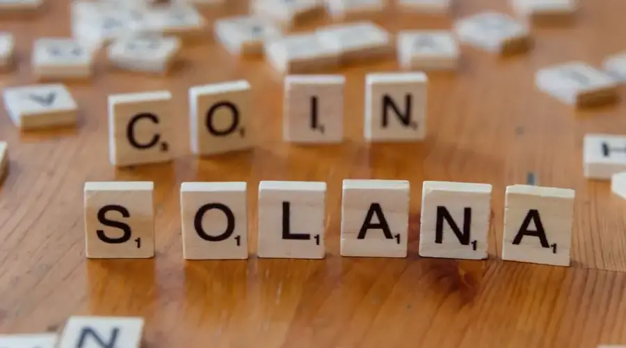 Scrabble tiles creatively arranged to spell 'Solana Coin', highlighting cryptocurrency concept.