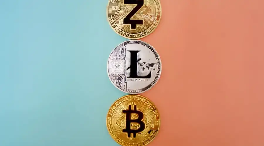 Colorful display of Zcash, Litecoin, and Bitcoin coins on gradient background.