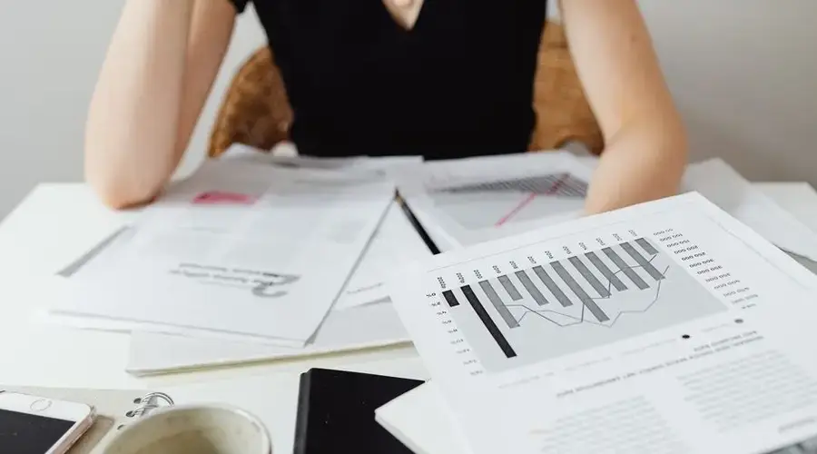Close-up of financial documents and graphs on a desk, showcasing business analysis.