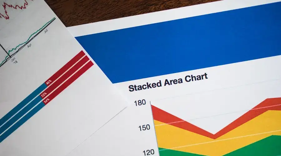 Vivid stacked area chart and graphs on paper, showcasing data analysis.