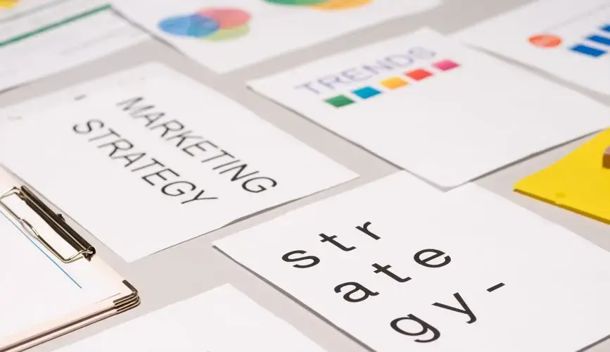 A top view of marketing strategy documents and graphs arranged on a desk, showcasing business planning.