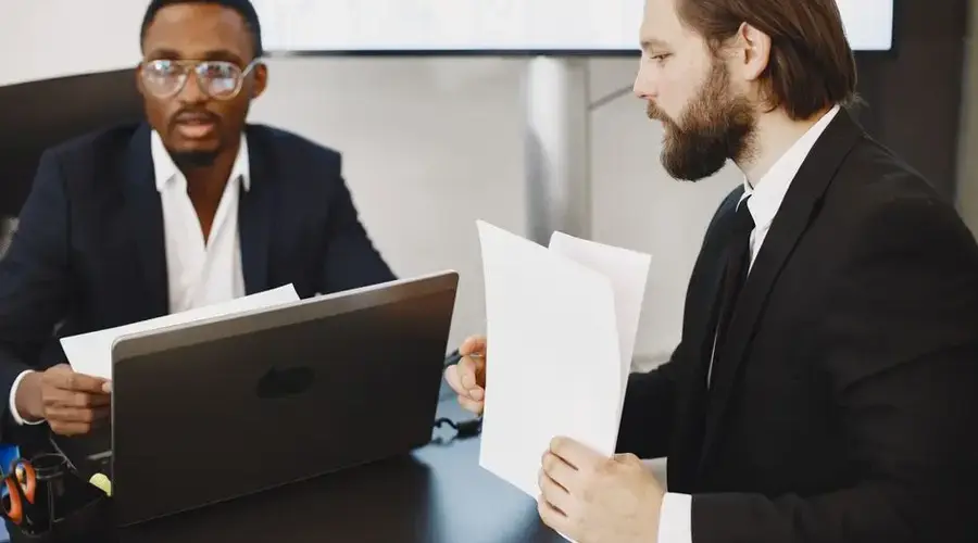 Two businessmen in a meeting discussing plans in a modern office.