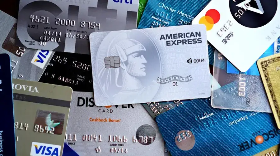 Close-up image of various credit and debit cards including Visa, MasterCard, American Express, and Discover.