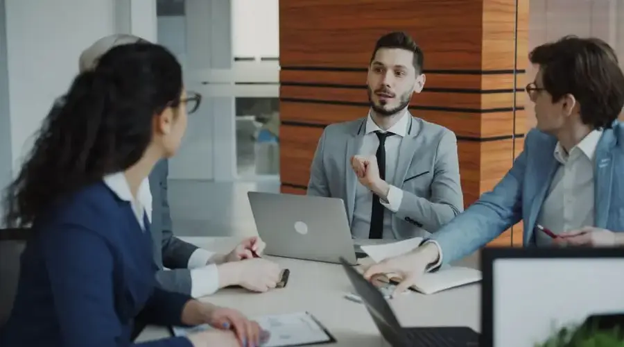 Professional business team collaborating in a modern office meeting.