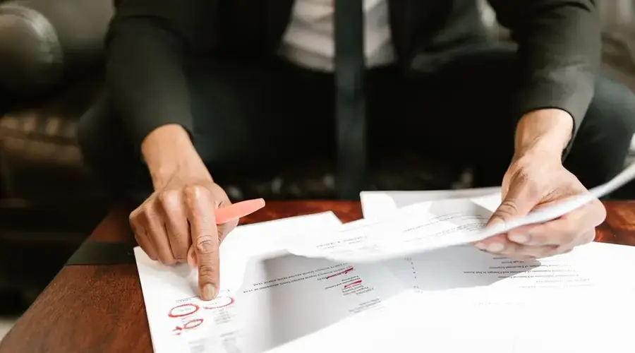 A businessman analyzing financial documents with important data and figures on a desk, ideal for business analytics and accounting themes.
