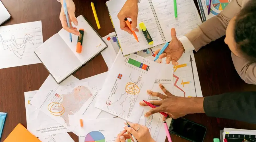 Business professionals collaborating over charts and data in a conference room.