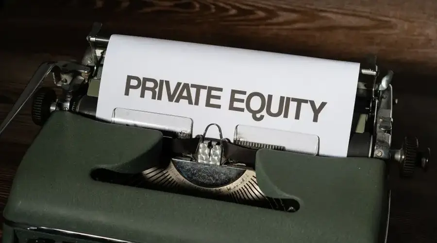 Close-up of a vintage typewriter with paper displaying 'Private Equity'.