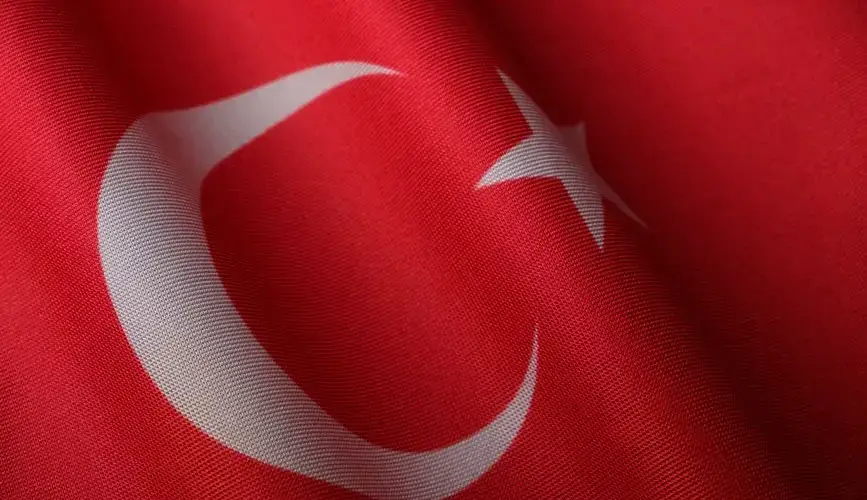 An elegant close-up of the Turkish flag showcasing its vibrant red and white colors.