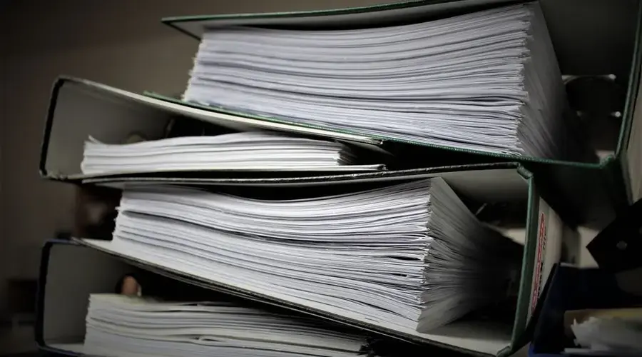 Close-up of stacked binders filled with documents for office or educational use.