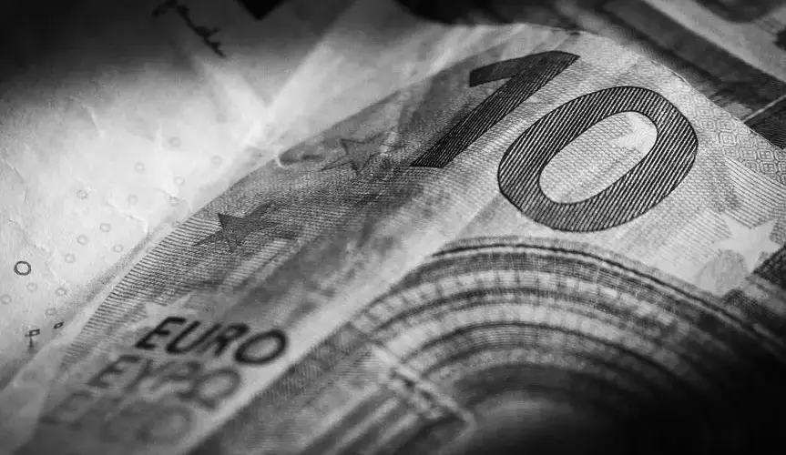 Monochrome macro photograph of a ten euro banknote highlighting intricate details and textures.