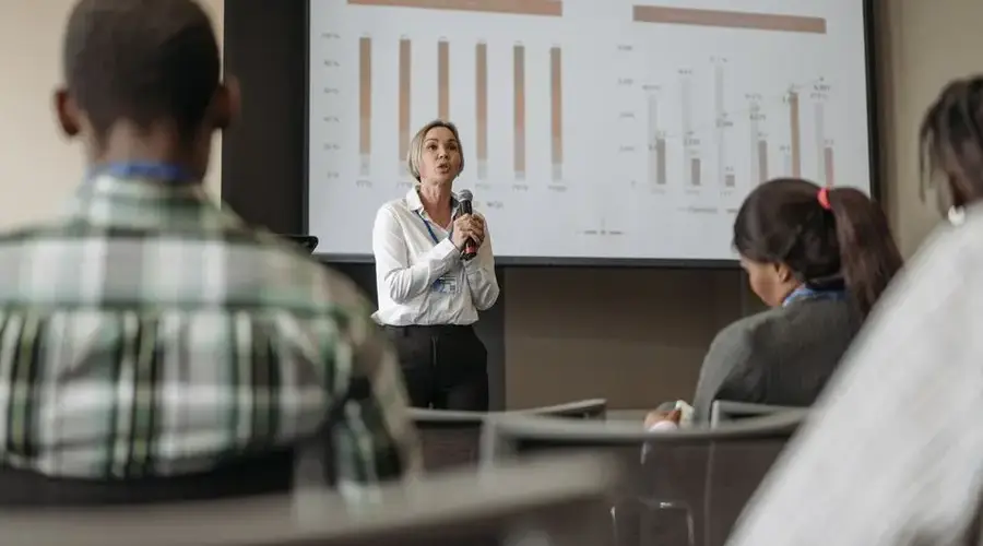 Professional presentation on revenue split by quarter and geography during a business conference.