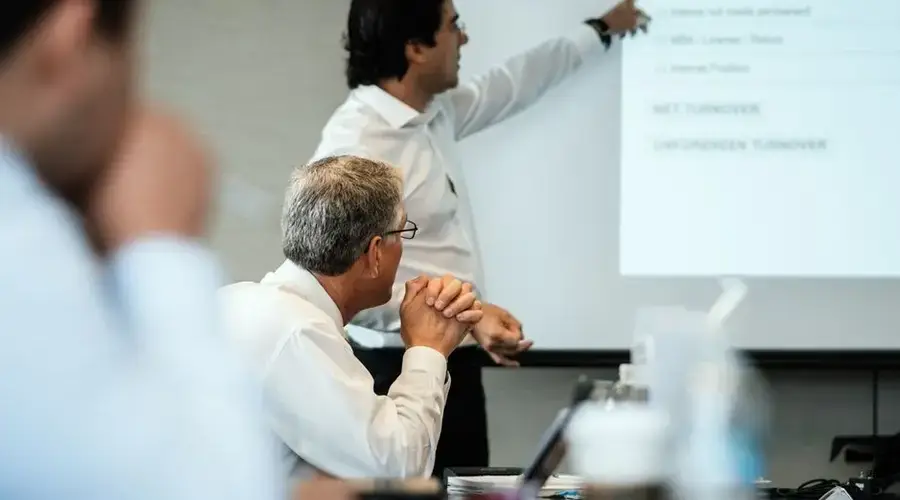 Professional setting with team members focused on a business presentation. Ideal for corporate themes.