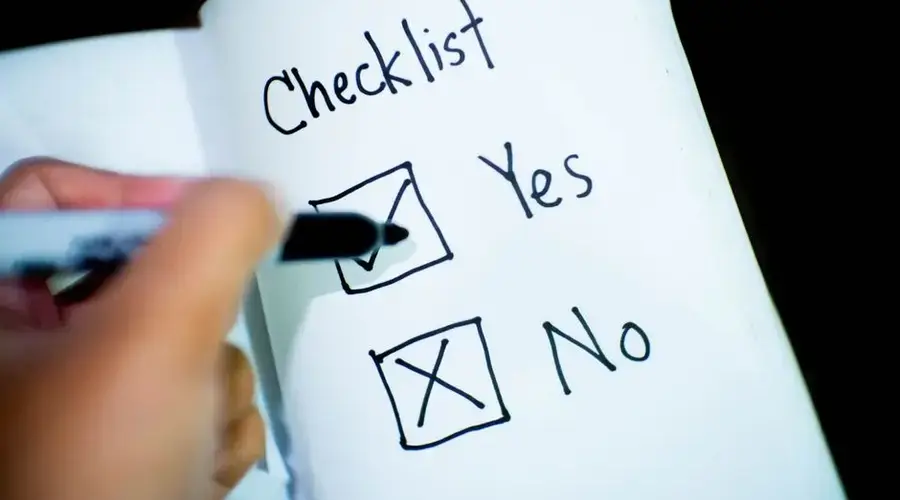 A notebook featuring a checklist with a marked 'Yes' box, captured in a close-up shot.