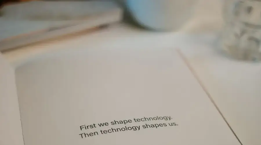 Open book with quote on technology's influence, perfect for tech inspiration.