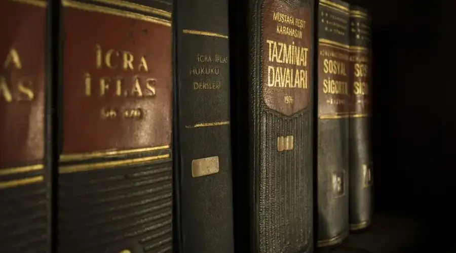 Detailed close-up of law and regulation books on a bookshelf, emphasizing education and knowledge.