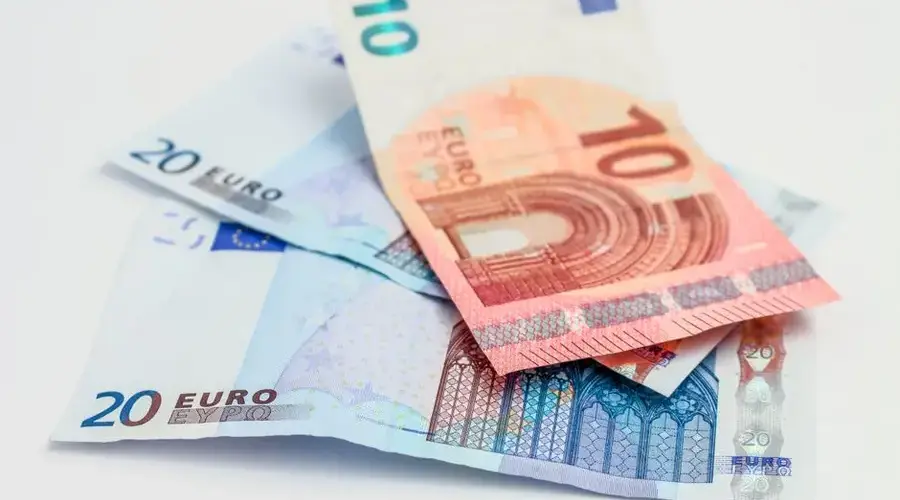 Stack of 10 and 20 euro banknotes symbolizing finance and economy.