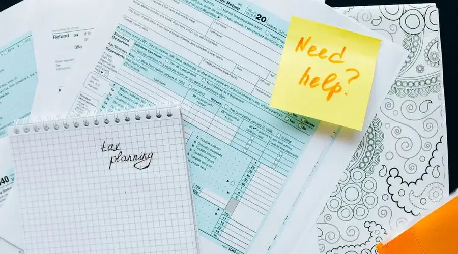 Tax documents and a note suggest tax planning and assistance needs.