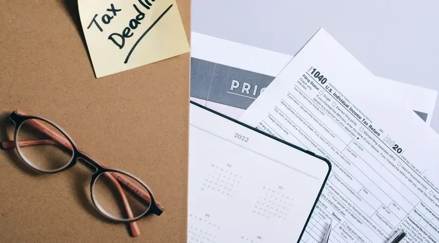 Organized tax preparation essentials with calendar, forms, and deadline reminder.
