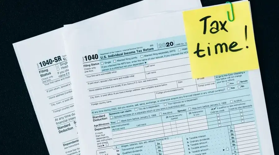 U.S. tax documents with a 'Tax time!' reminder, highlighting the importance of filing deadlines.