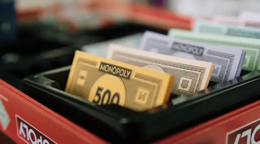Detailed view of Monopoly game money and box, ideal for board game enthusiasts.